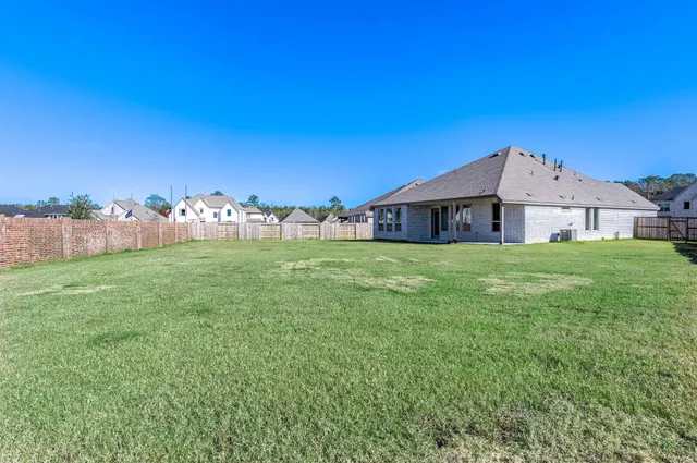 a view of a house with yard and a tree