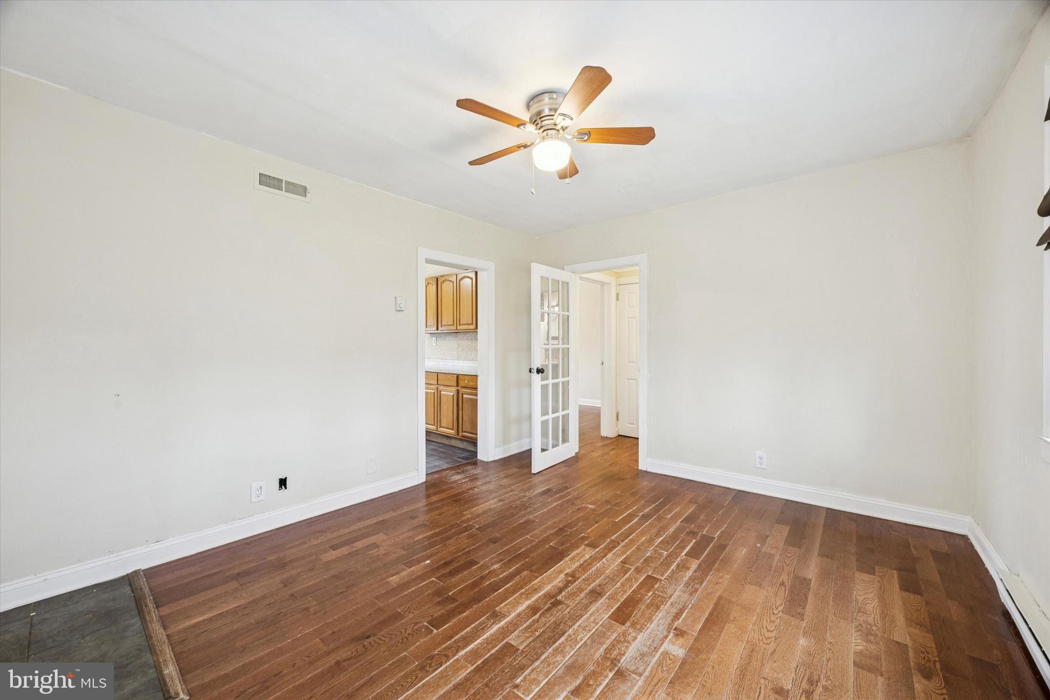 403 Denver Court Wallingford, PA 19086 - Photo 4 of 13 a view of a livingroom with wooden floor and a ceiling fan