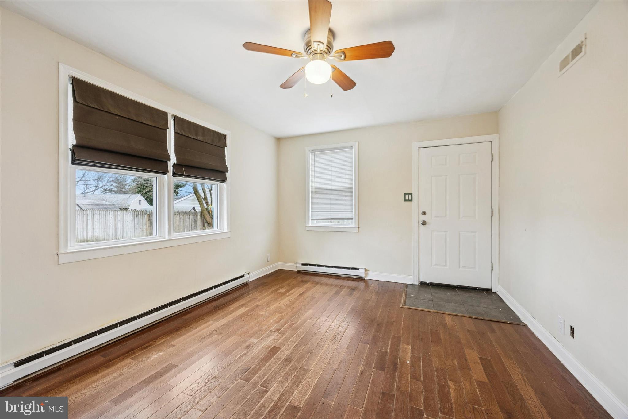 403 Denver Court Wallingford, PA 19086 - Photo 5 of 13 wooden floor in an empty room with a window