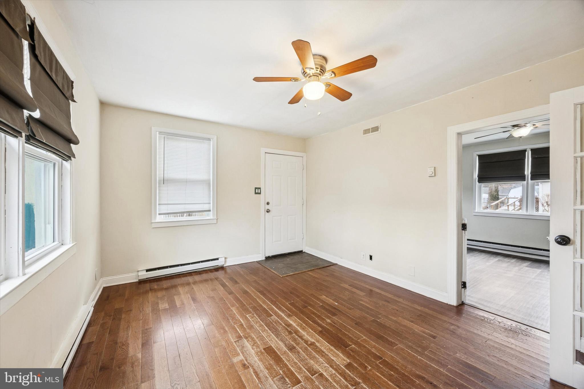 403 Denver Court Wallingford, PA 19086 - Photo 6 of 13 wooden floor in an empty room with a window