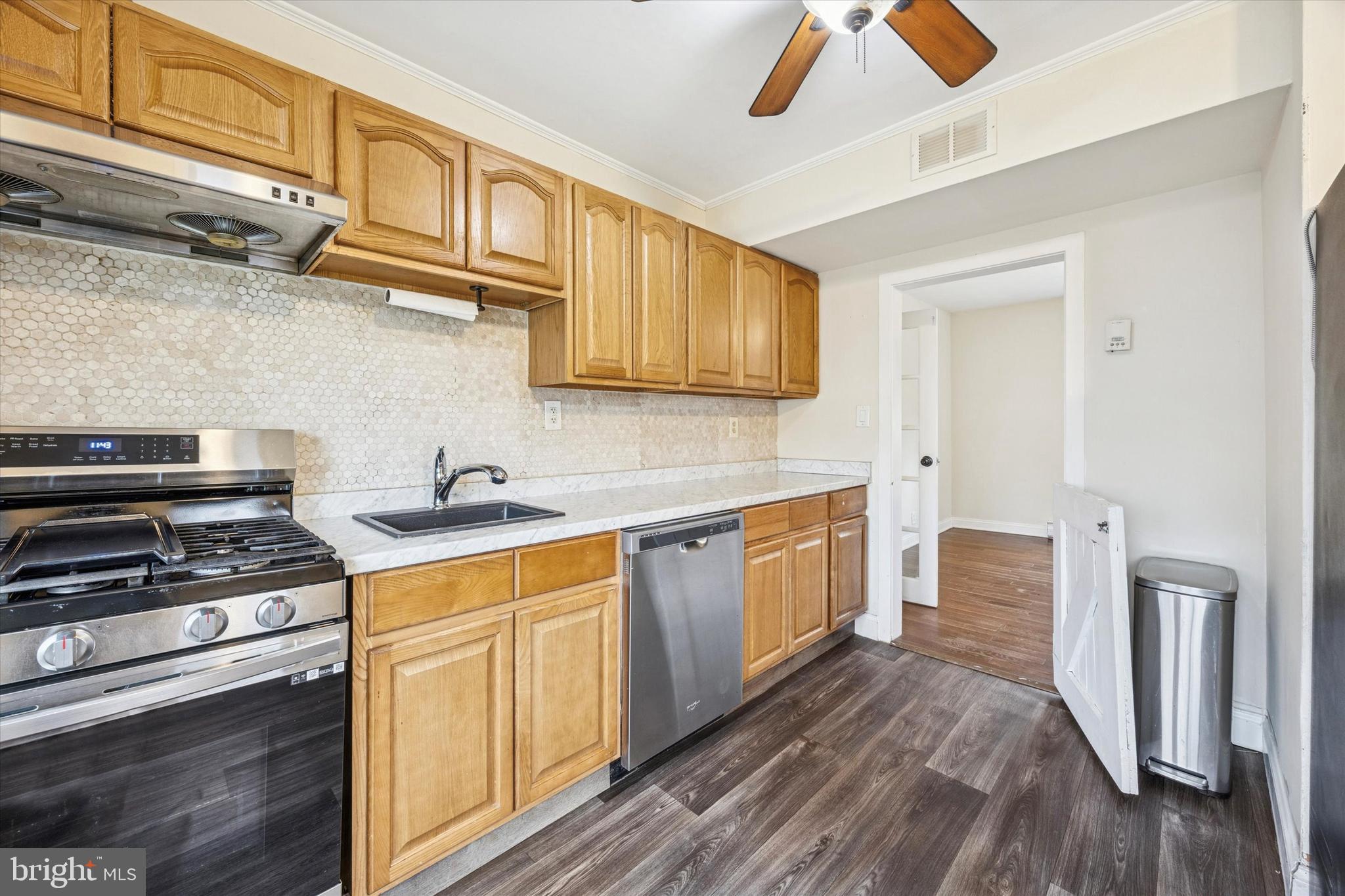 403 Denver Court Wallingford, PA 19086 - Photo 7 of 13 a kitchen with stainless steel appliances granite countertop a stove and a sink