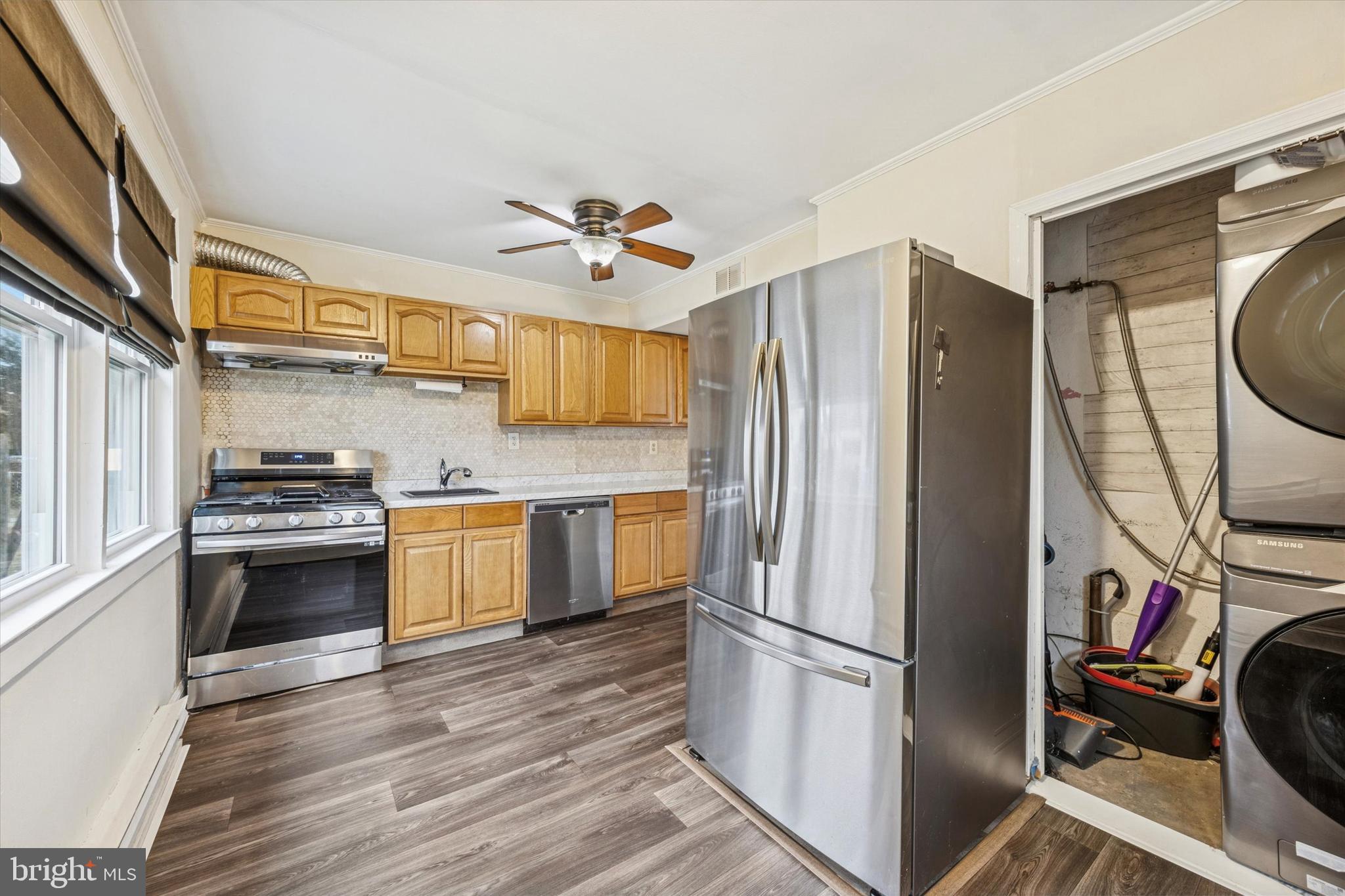 403 Denver Court Wallingford, PA 19086 - Photo 8 of 13 a kitchen with stainless steel appliances a stove a refrigerator and a sink