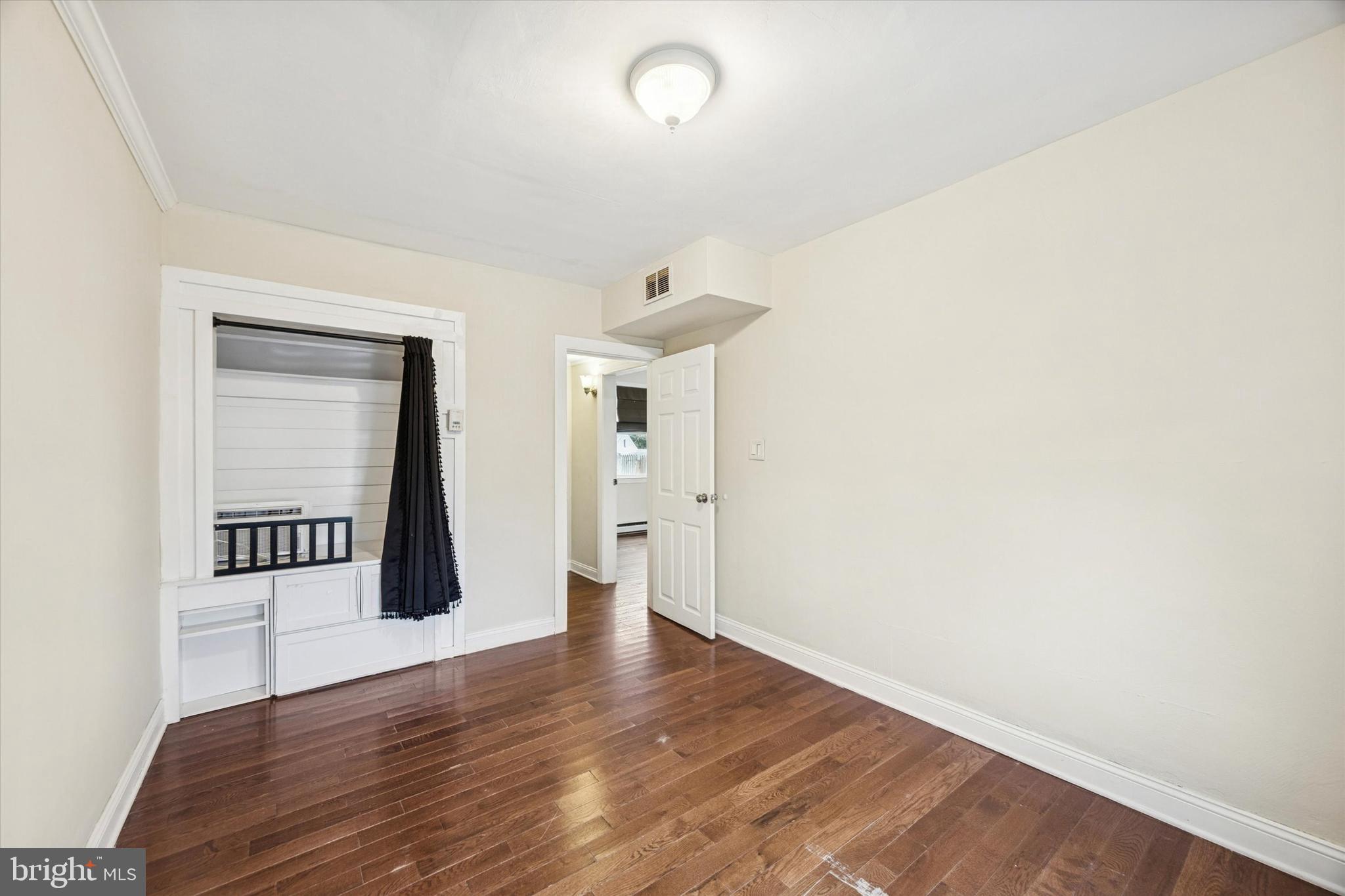 403 Denver Court Wallingford, PA 19086 - Photo 10 of 13 a view of a room with wooden floor and window