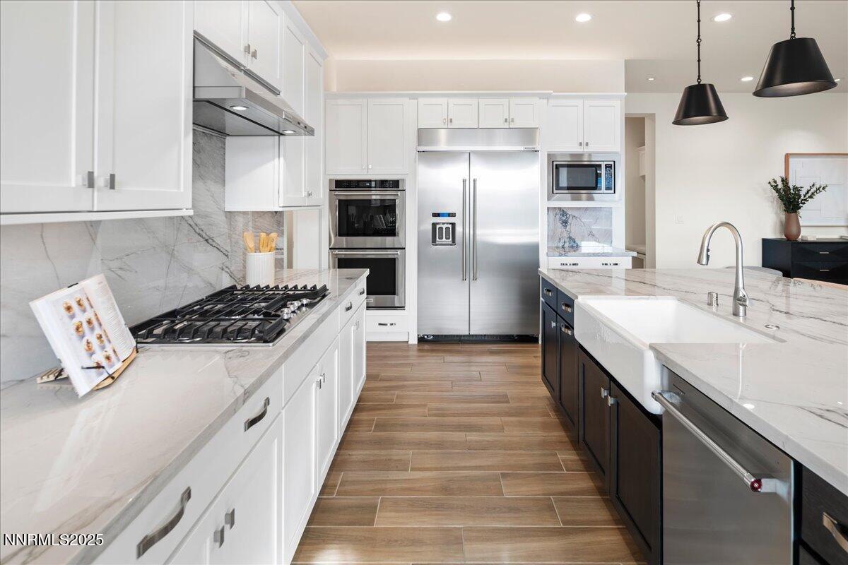 2330 Blushing Rock Drive Reno, NV 89521 - Photo 12 of 60 a large kitchen with stainless steel appliances a sink dishwasher a refrigerator a stove oven with wooden floor