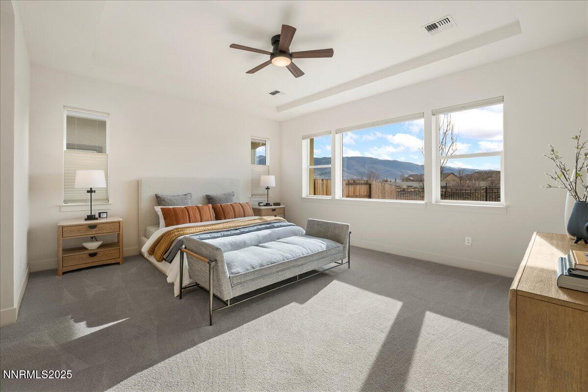 2330 Blushing Rock Drive Reno, NV 89521 - Photo 18 of 60 a bedroom with a large bed and a chandelier fan