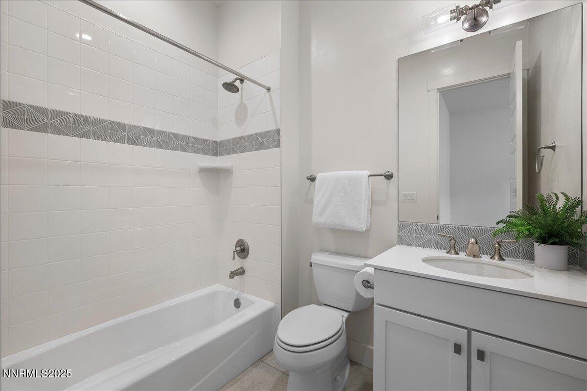 2330 Blushing Rock Drive Reno, NV 89521 - Photo 35 of 60 a bathroom with a sink a toilet a mirror a vanity and shower