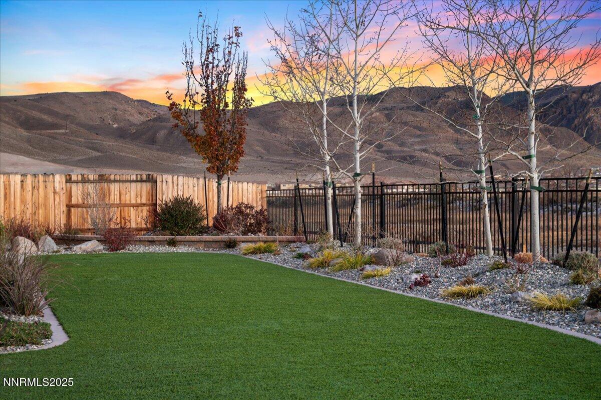 2330 Blushing Rock Drive Reno, NV 89521 - Photo 47 of 60 a view of a backyard with table and chairs potted plants and large tree