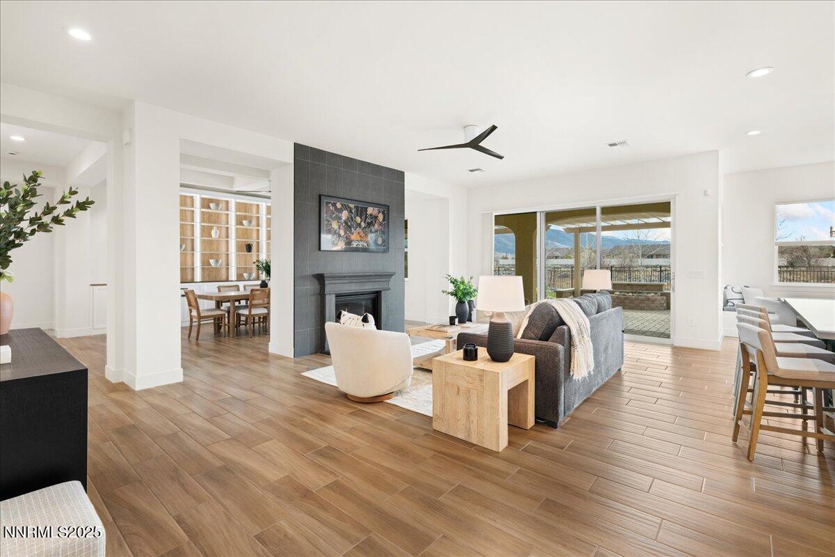 2330 Blushing Rock Drive Reno, NV 89521 - Photo 7 of 60 a living room with fireplace furniture and a wooden floor