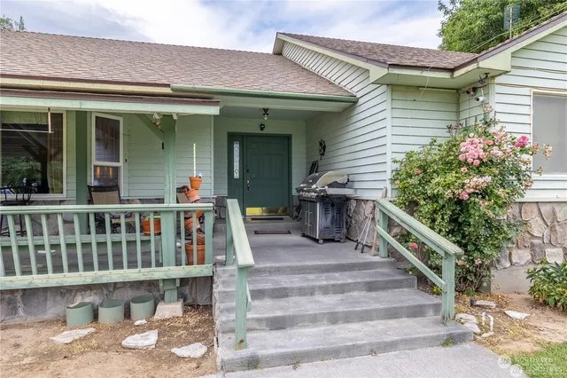 a view of house with outdoor seating and stairs