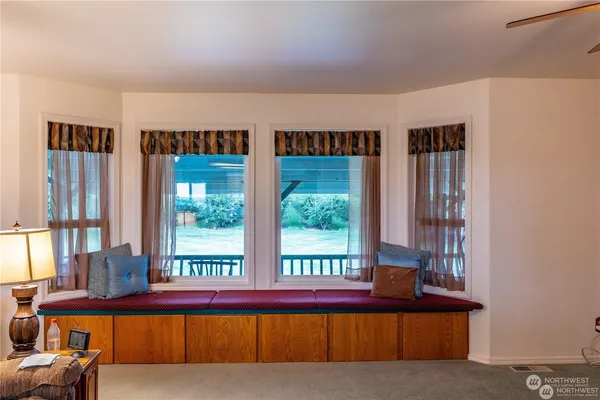 a living room with furniture and large window