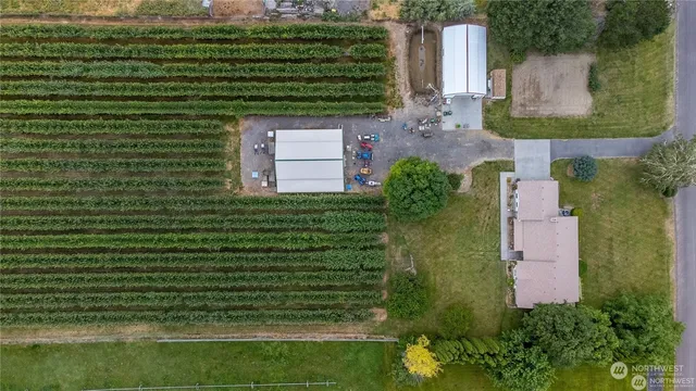 an aerial view of a house with a yard