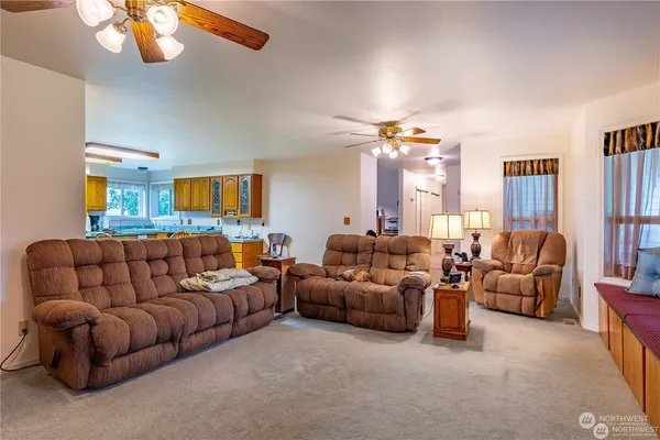 a living room with furniture a large window and a flat screen tv
