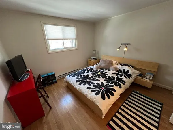 a bed sitting in a bedroom next to a window