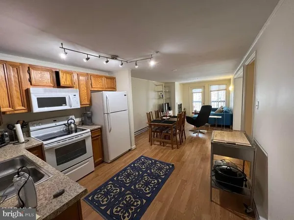 a kitchen with stainless steel appliances granite countertop a stove refrigerator and a stove