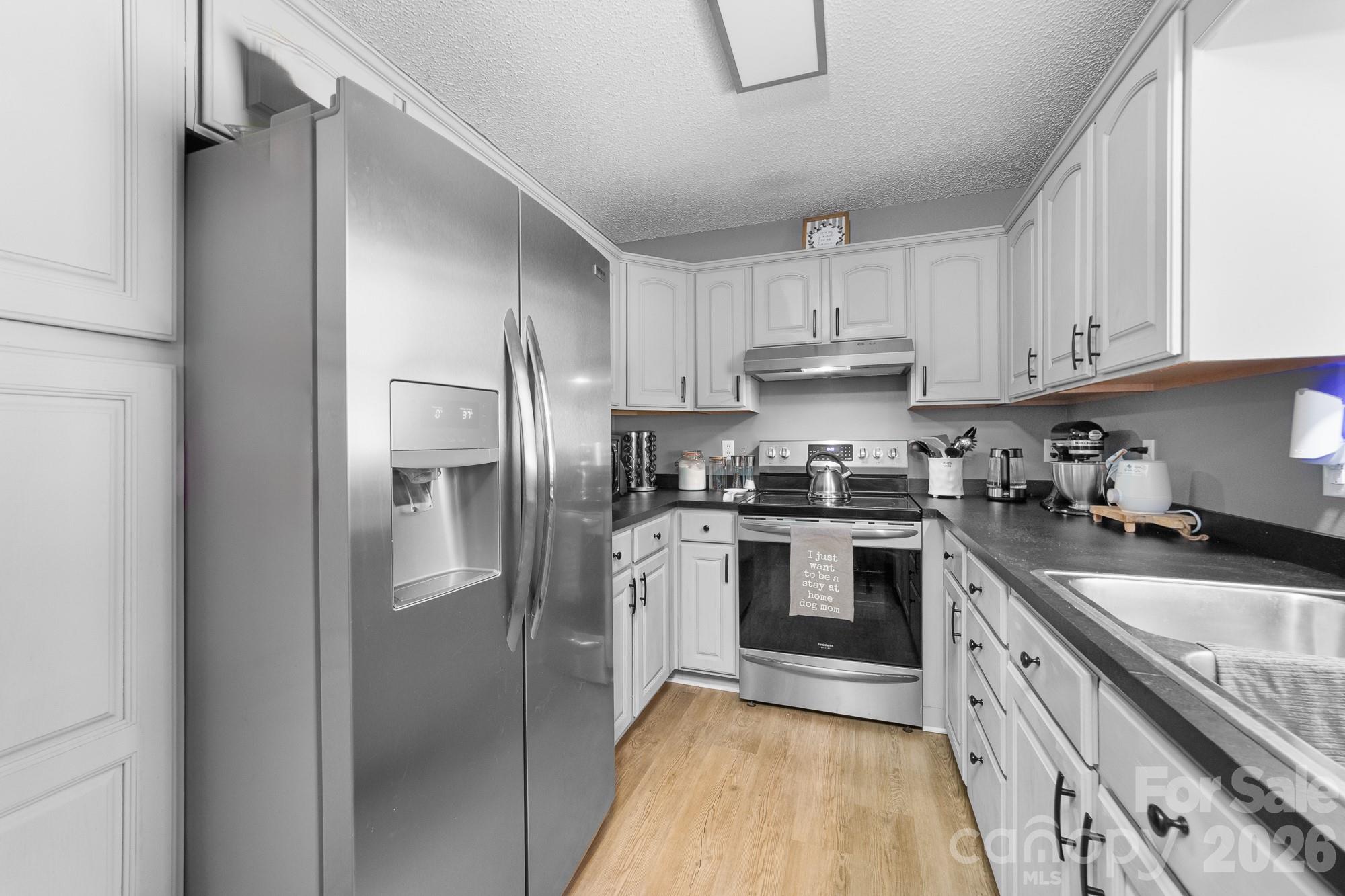 248 Jack McKinney Road Forest City, NC 28043 - Photo 25 of 29 a kitchen with granite countertop a refrigerator stove and sink