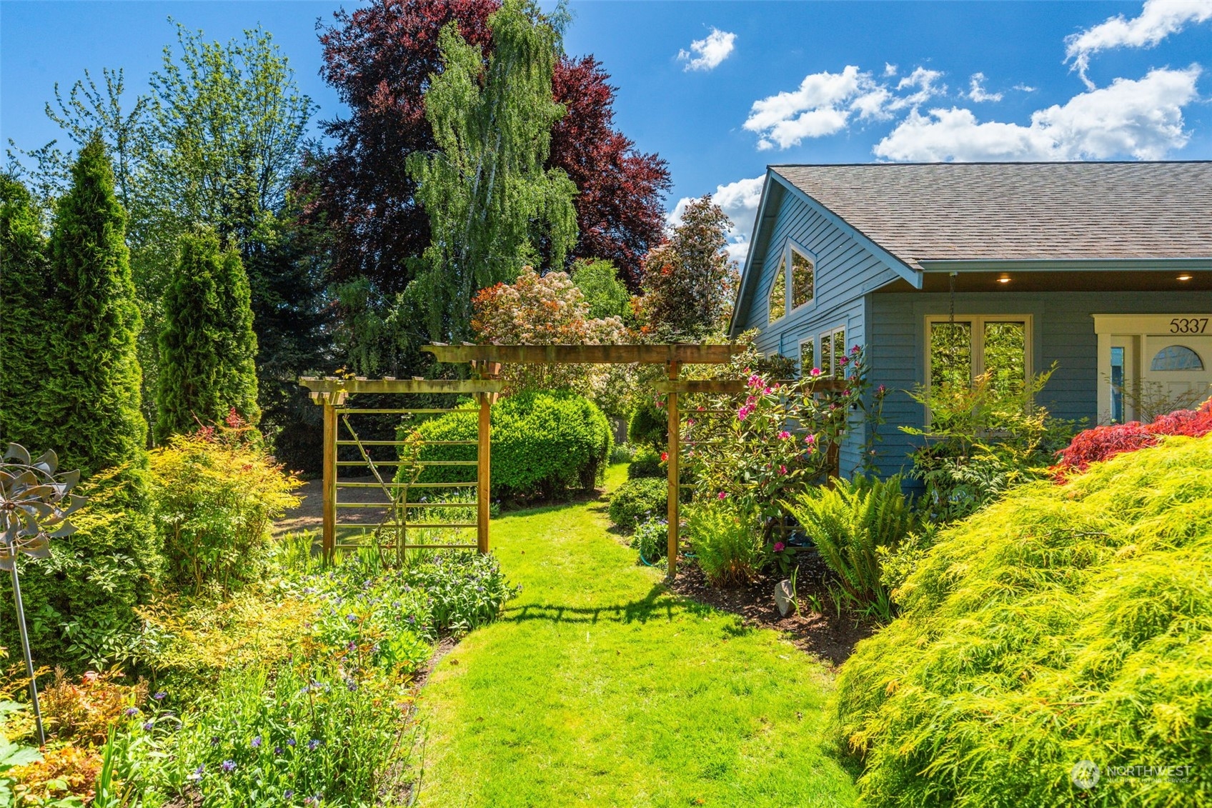 5337 South Kenyon Street Seattle, WA 98118 - Photo 29 of 37 a view of a house with a garden