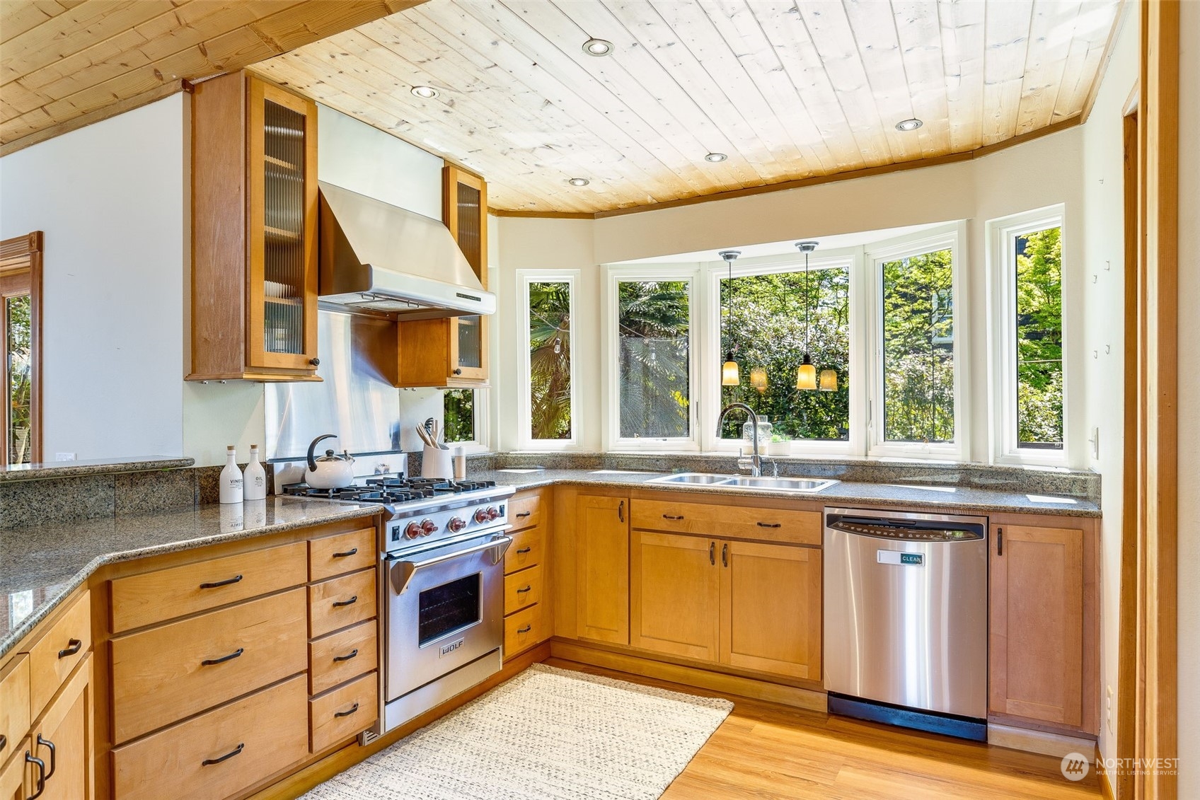 5337 South Kenyon Street Seattle, WA 98118 - Photo 9 of 37 a kitchen with stainless steel appliances granite countertop a stove and a sink