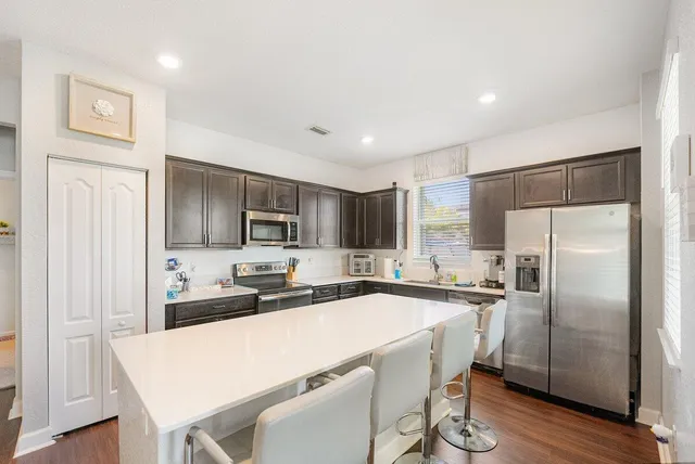 a kitchen with stainless steel appliances a refrigerator and a sink