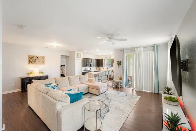 a living room with furniture flat screen tv and white floor