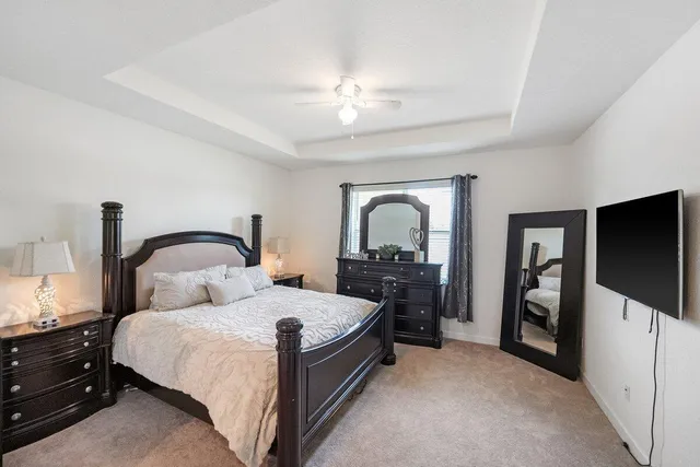 a bedroom with a bed and a large mirror