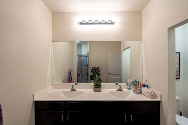 a bathroom with double sink and a mirror