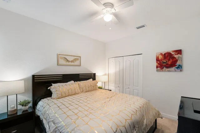 a bedroom with a bed and a painting on the wall