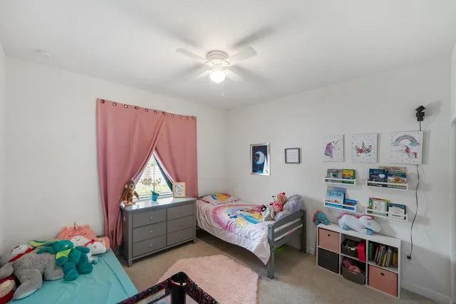 a bedroom with bed and a window