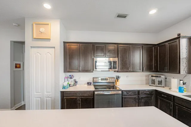 a kitchen with stainless steel appliances granite countertop a stove and a sink