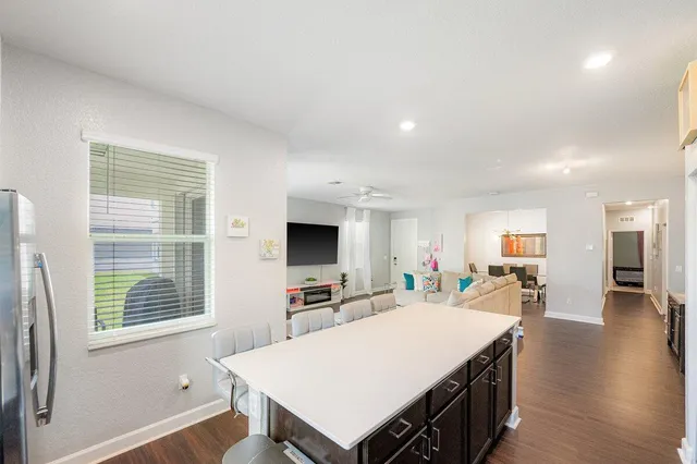 a large living room with stainless steel appliances