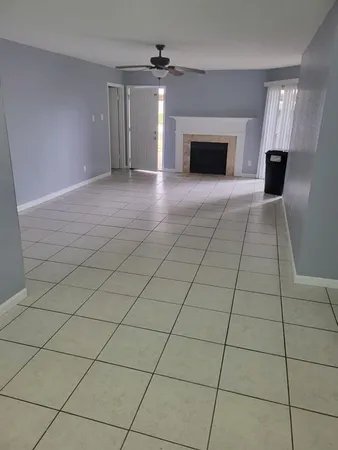 a view of an empty room with a fireplace