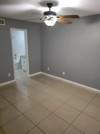 a view of a chandelier fan and wood floor