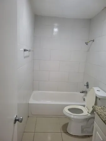 a bathroom with a bathtub and a toilet