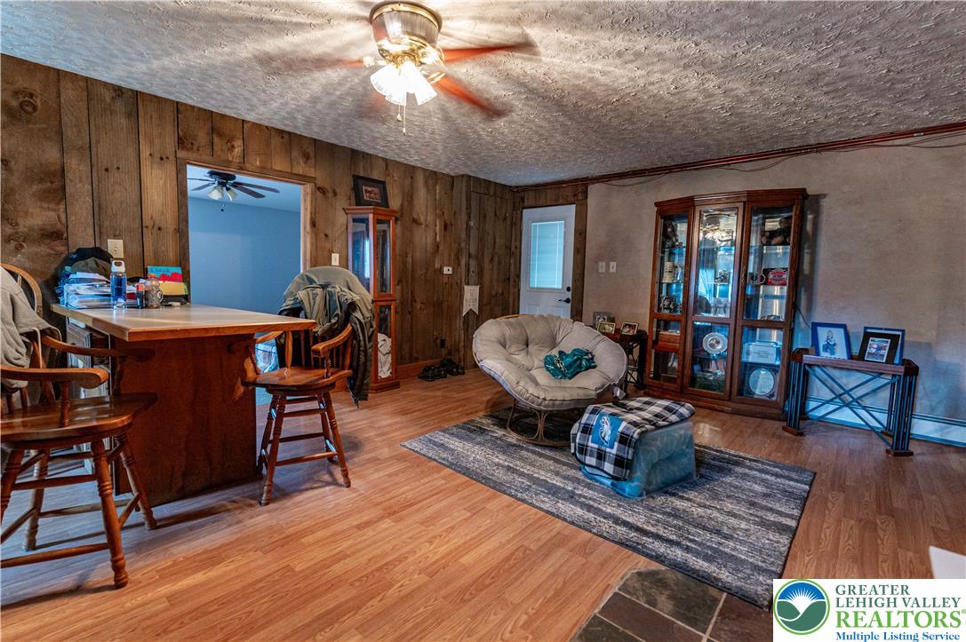 2485 Hieter Road Quakertown, PA 18951 - Photo 58 of 97 Natural wood paneling graces the walls of this inviting living space, offering warmth and character.