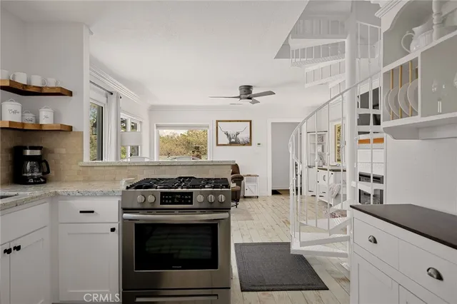a kitchen with stainless steel appliances granite countertop a stove and a cabinets