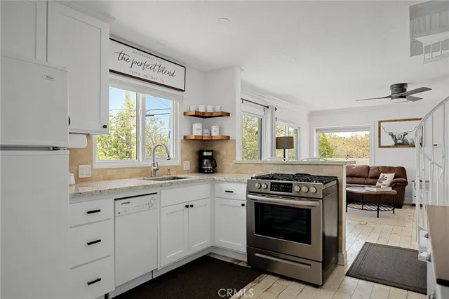 a kitchen with cabinets appliances and a window