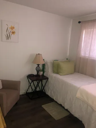 a bedroom with a bed and window