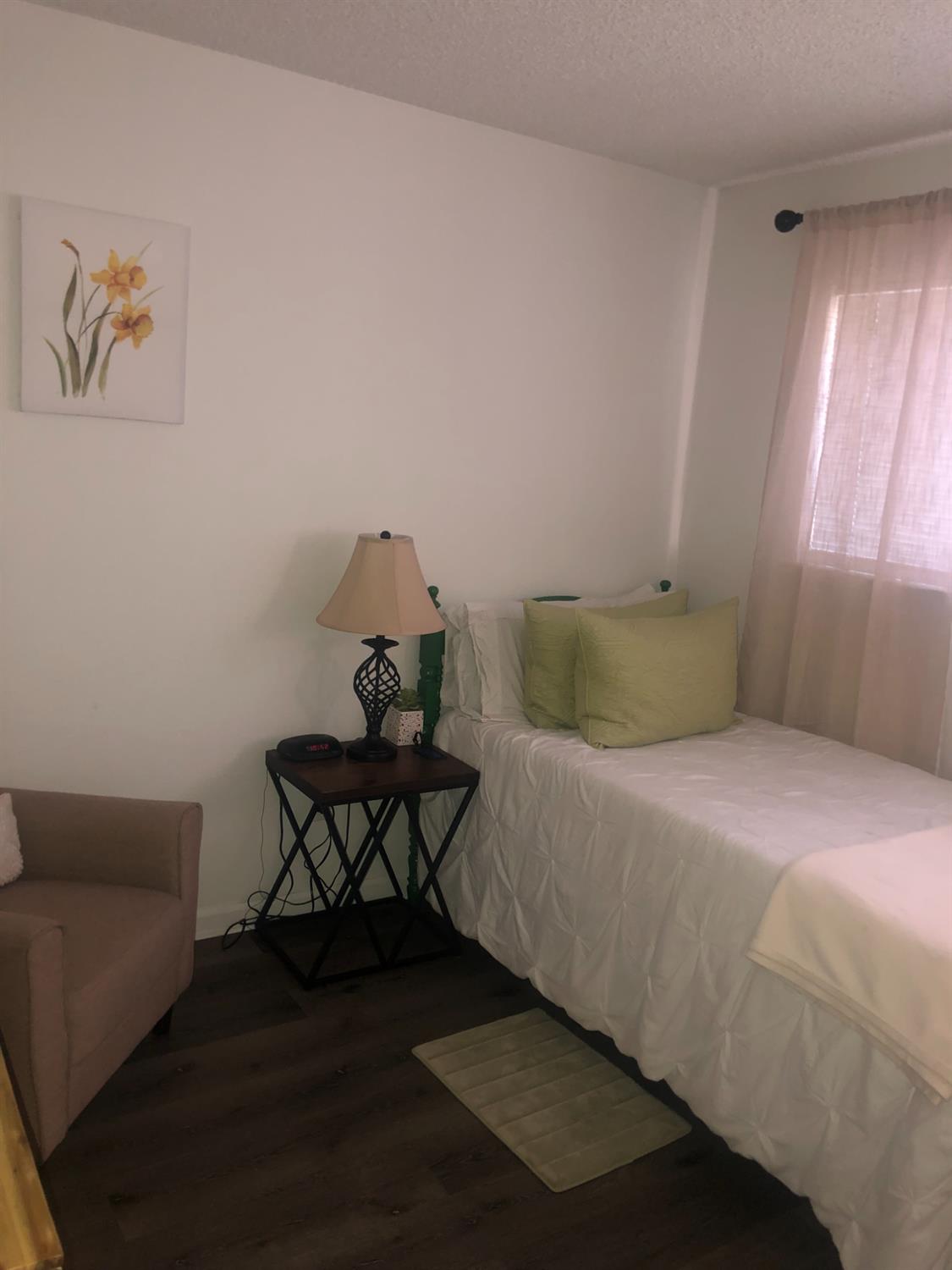 5604 Walerga Road, Unit 1 Sacramento, CA 95842 - Photo 4 of 9 a bedroom with a bed and window