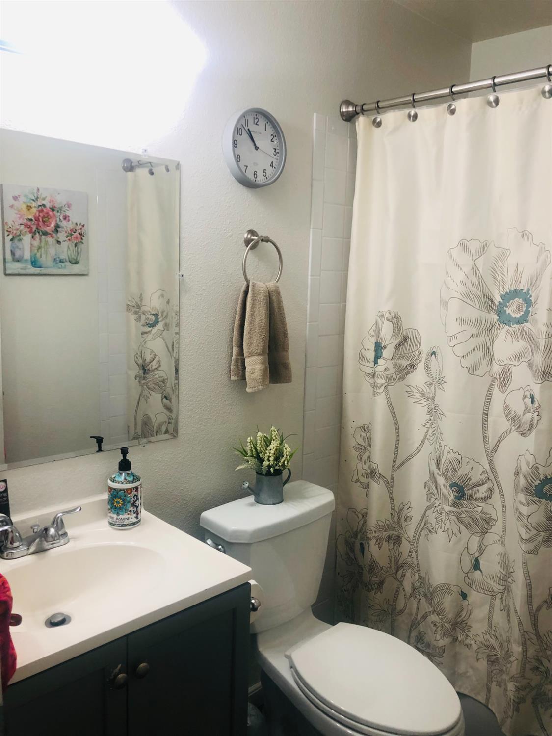 5604 Walerga Road, Unit 1 Sacramento, CA 95842 - Photo 7 of 9 a bathroom with a sink and a mirror