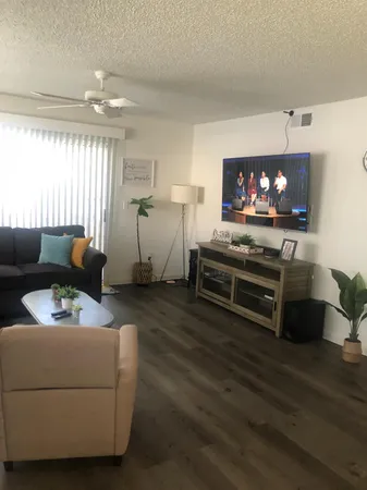 a living room with furniture and a flat screen tv