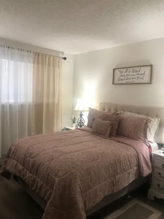a bedroom with a bed and a window