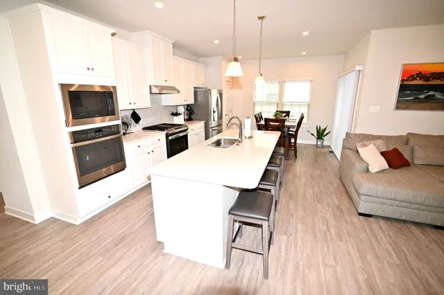 a view of a dining room with furniture wooden floor and a chandelier