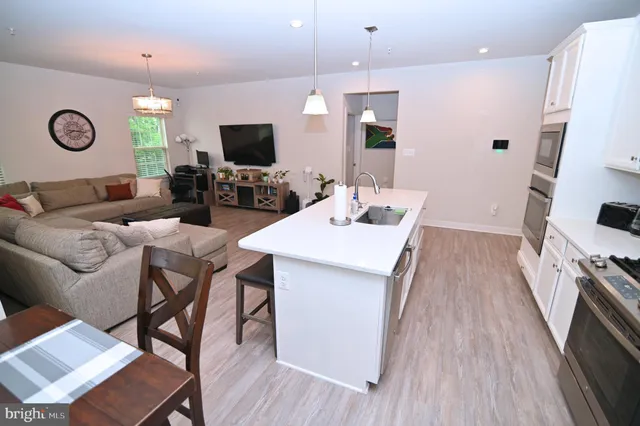 a bathroom with a sink a toilet and shower curtain