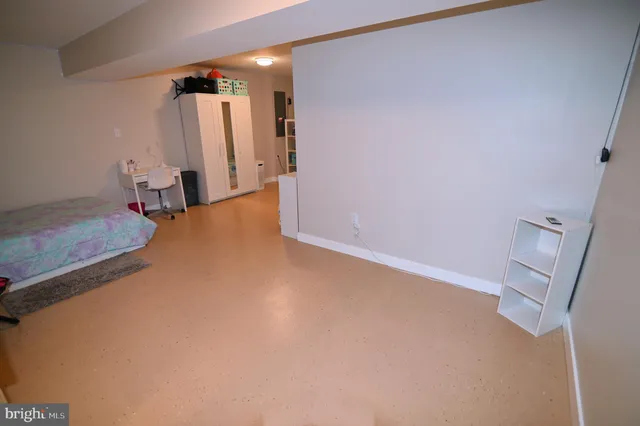 a living room with furniture gym equipment and a large window