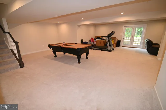 a bathroom with a sink a toilet a mirror and shower