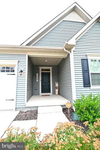 a living room with furniture kitchen view and a chandelier