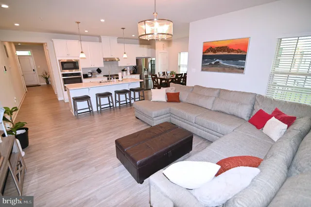 a kitchen with granite countertop a stove a sink and a microwave