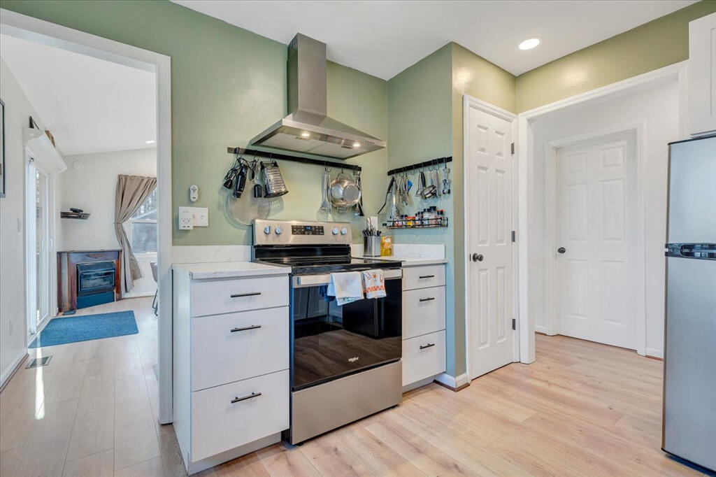 1039 Fosters Knob Road Blue Ridge, VA 24064 - Photo 13 of 45 a kitchen with stainless steel appliances a stove and cabinets
