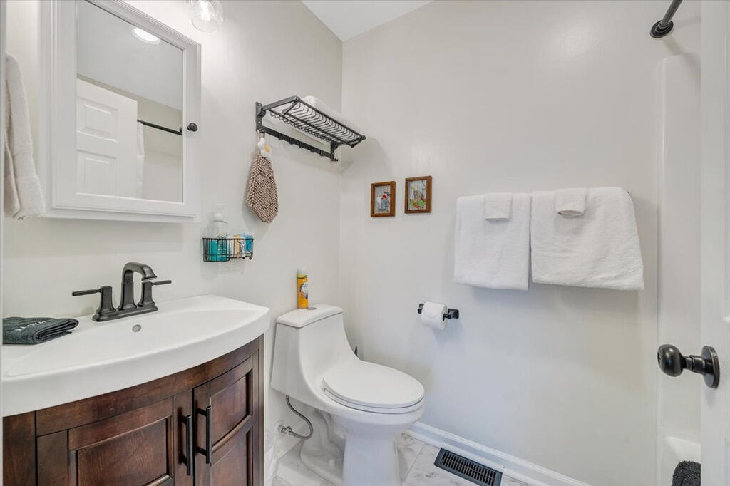 1039 Fosters Knob Road Blue Ridge, VA 24064 - Photo 15 of 45 a bathroom with a sink a toilet and mirror