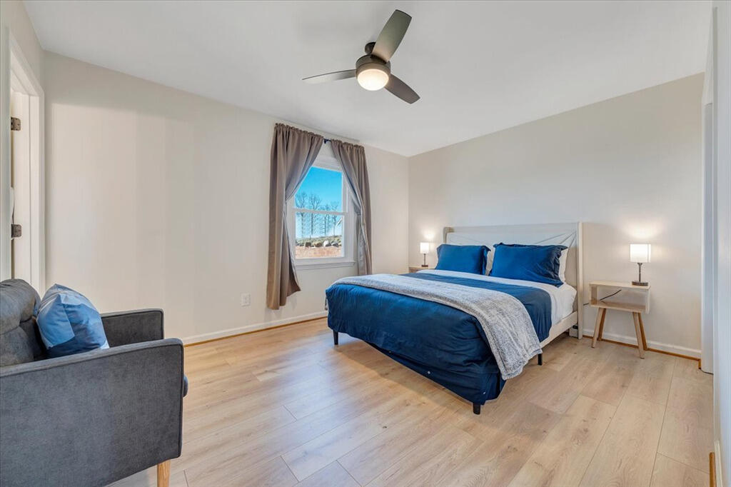 1039 Fosters Knob Road Blue Ridge, VA 24064 - Photo 17 of 45 a spacious bedroom with a bed and a couch