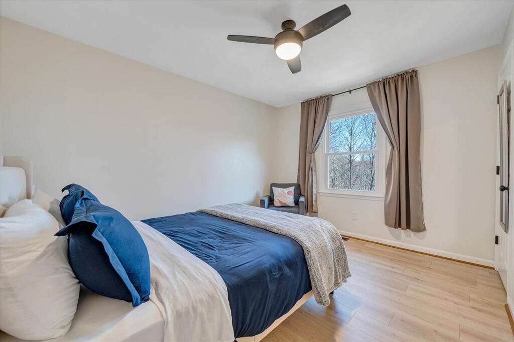 1039 Fosters Knob Road Blue Ridge, VA 24064 - Photo 20 of 45 a bedroom with a bed and a large window